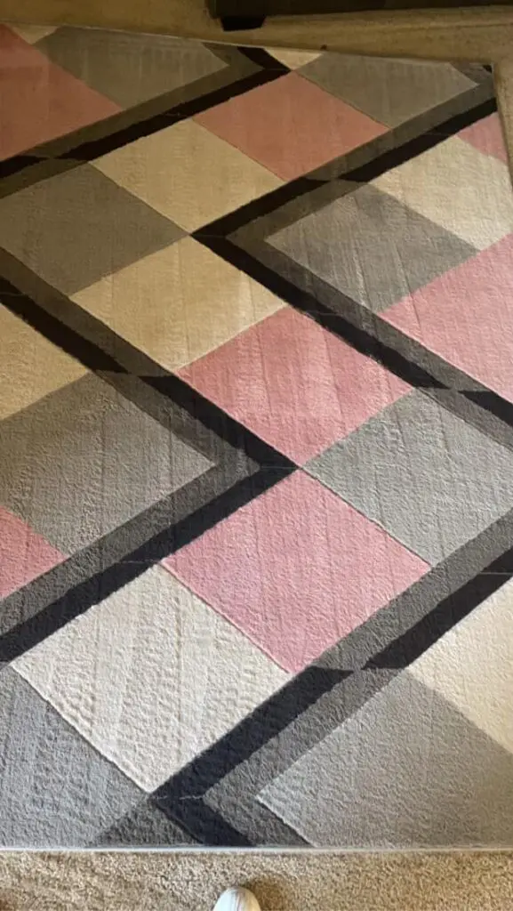 Geometric area rug with pink, gray, and white patterns, showcasing a modern design ideal for home and business decor, relevant to Central California King of Clean LLC's carpet cleaning services.