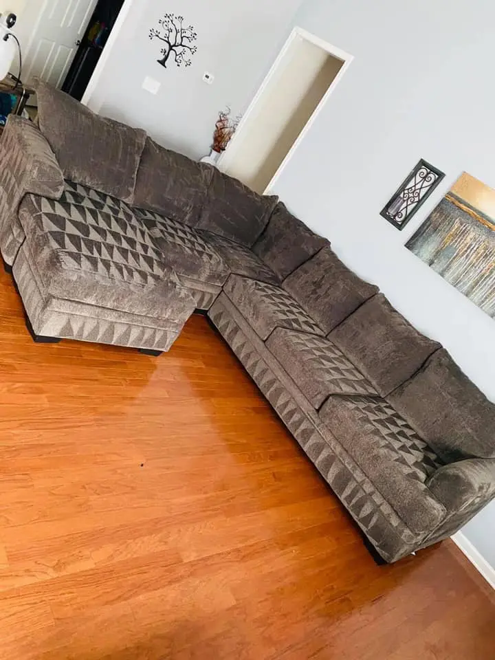 Upholstered sectional sofa in a living room, showcasing a clean and well-maintained appearance, highlighting upholstery cleaning services by Central California King of Clean LLC in Bakersfield.